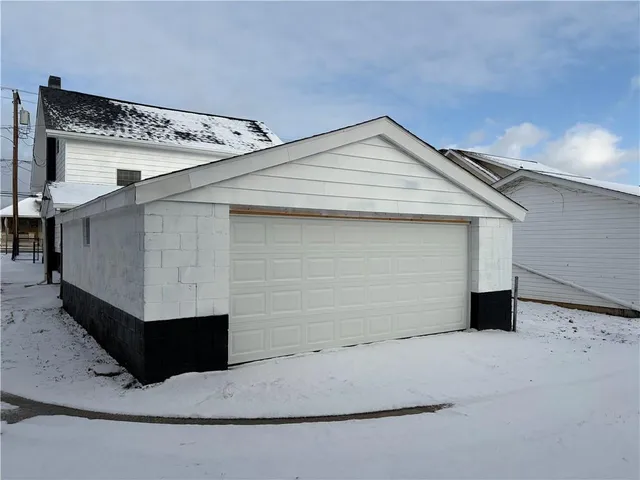 a kitchen with granite countertop white cabinets and a sink