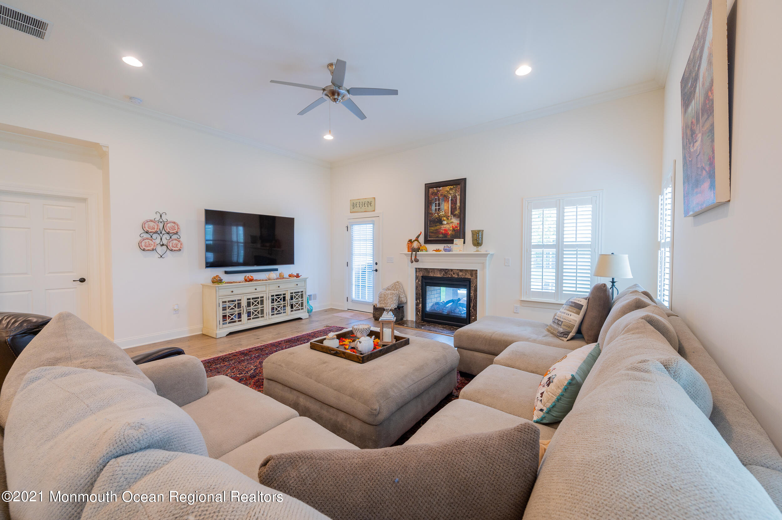 15 Starry Lane Barnegat, NJ 08005 - Photo 6 of 45 a living room with furniture a flat screen tv and a fireplace