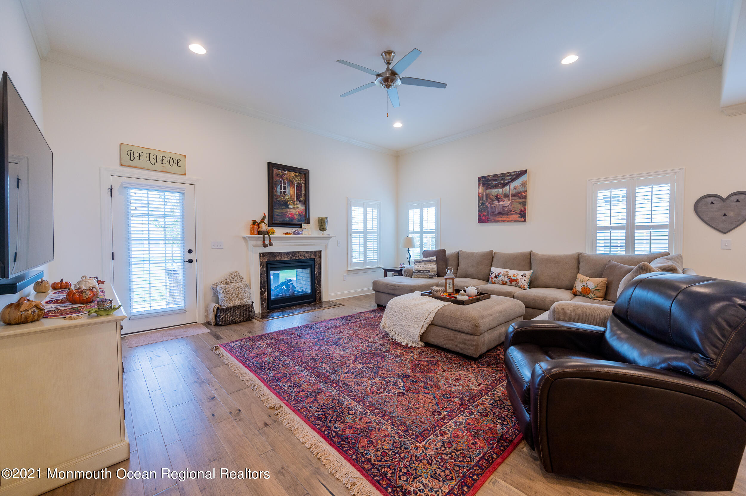 15 Starry Lane Barnegat, NJ 08005 - Photo 10 of 45 a living room with furniture a fireplace and a chandelier