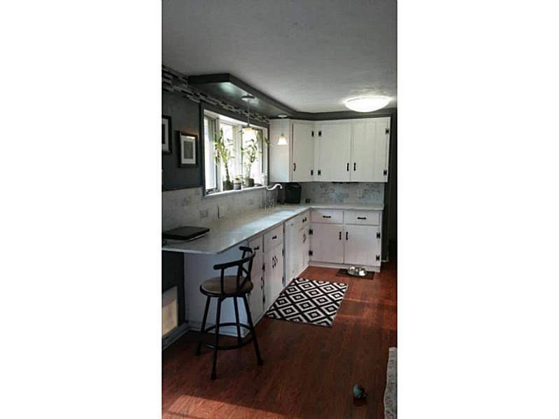 14 Shadbush Road Warwick, RI 02888 - Photo 3 of 12 Kitchen. Beautiful white kitchen with wonderful counterspace for the holiday buffet! Laminate floor is sooooo easy to dust! the slider to the back yard is right off the kitchen