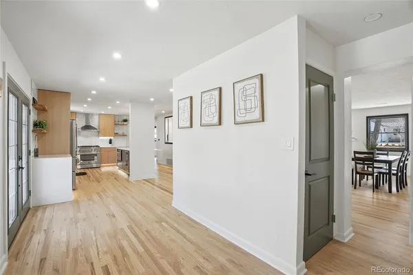 a view of a kitchen with furniture and wooden floor