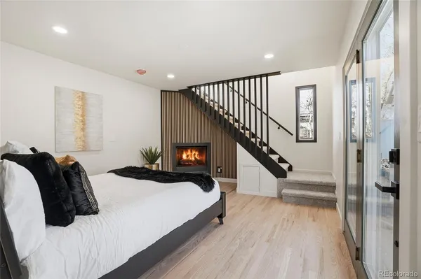 a bedroom with a bed and a wooden floor