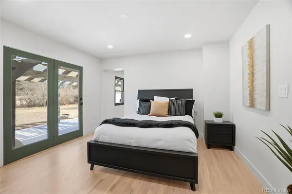 a bedroom with bed and large window
