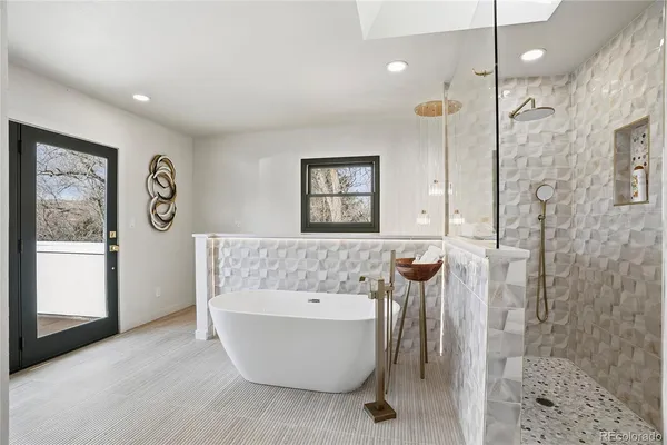 a bathroom with a bathtub and a shower