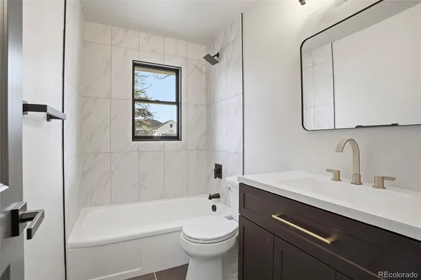 a bathroom with a sink a toilet and a bathtub