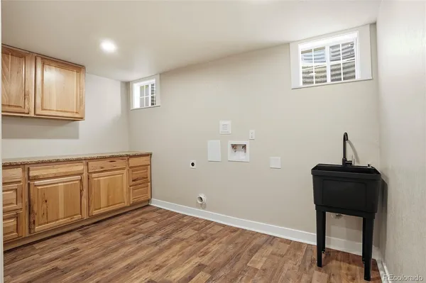 a kitchen with granite countertop cabinets and chair