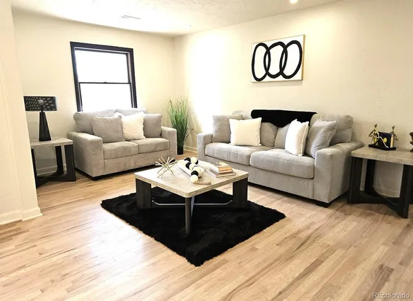 a living room with furniture rug and window