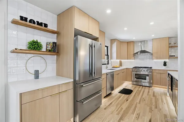 a kitchen with a refrigerator and a stove top oven
