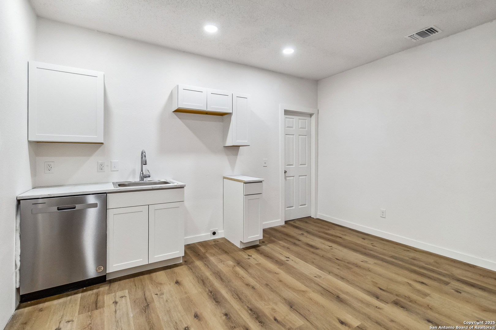 1206 West Hein Road, Unit 102 San Antonio, TX 78220 - Photo 3 of 7 a kitchen with a sink cabinets and wooden floor