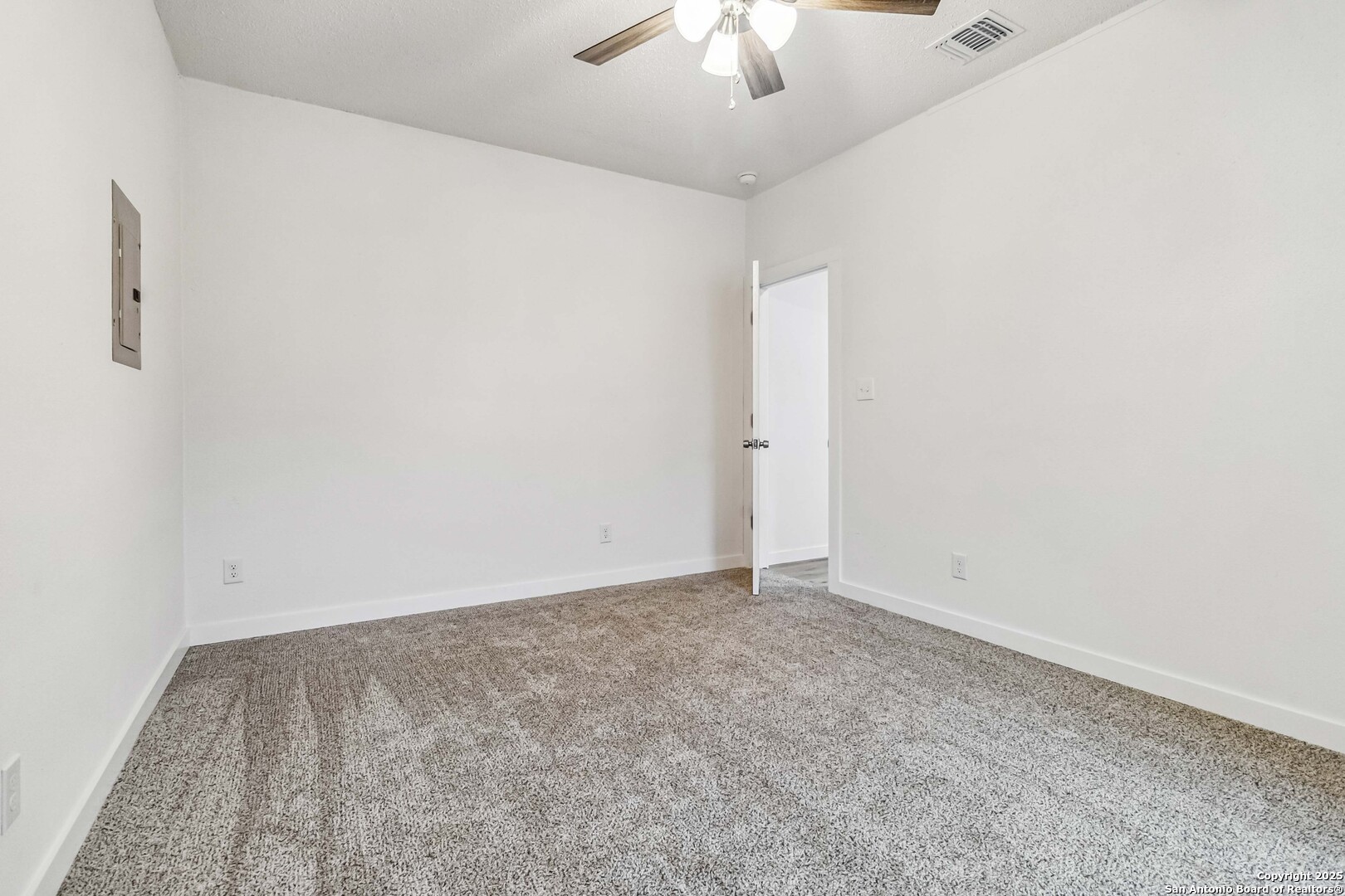 1206 West Hein Road, Unit 102 San Antonio, TX 78220 - Photo 4 of 7 an empty room with a chandelier fan