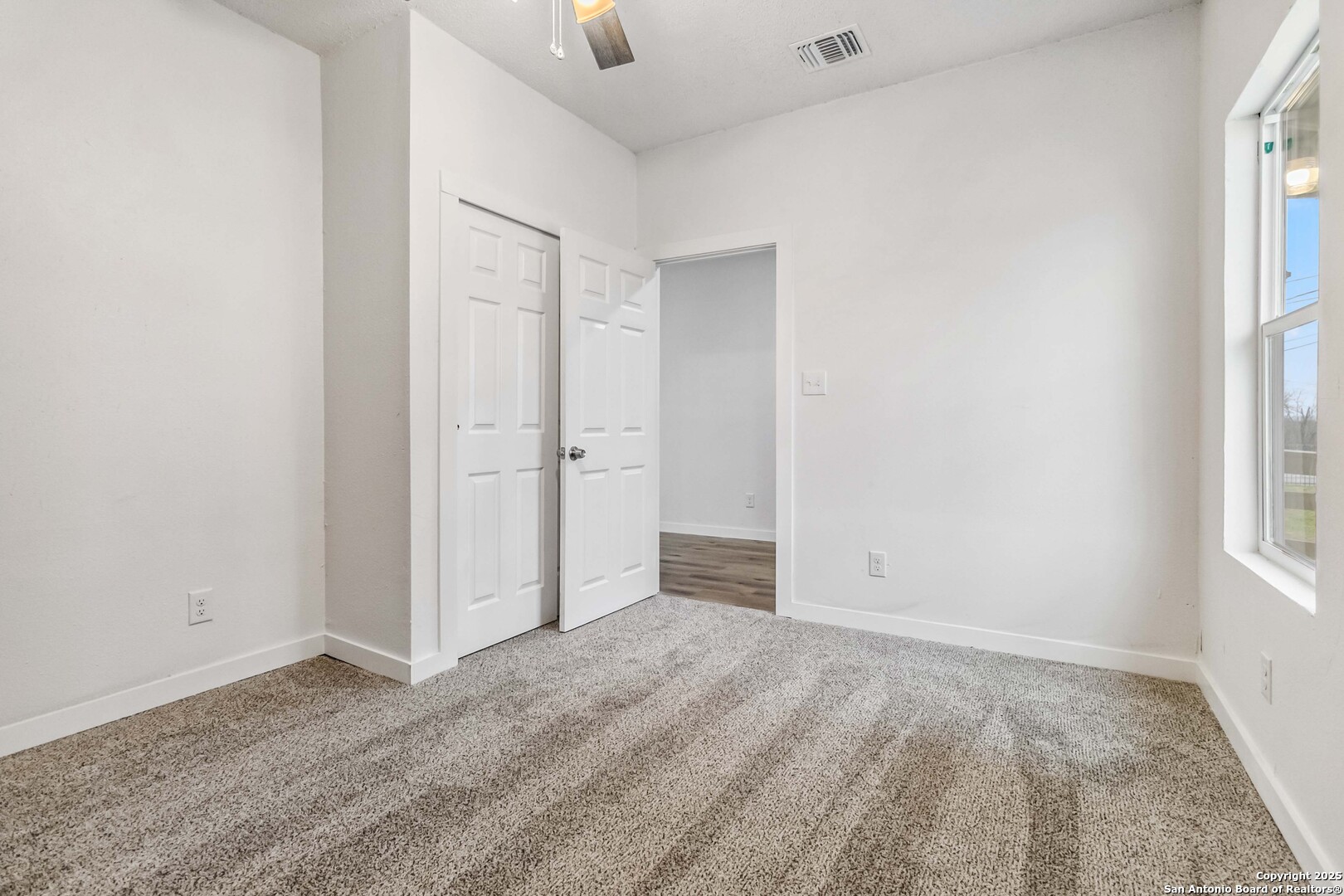1206 West Hein Road, Unit 102 San Antonio, TX 78220 - Photo 6 of 7 an empty room with windows and closet