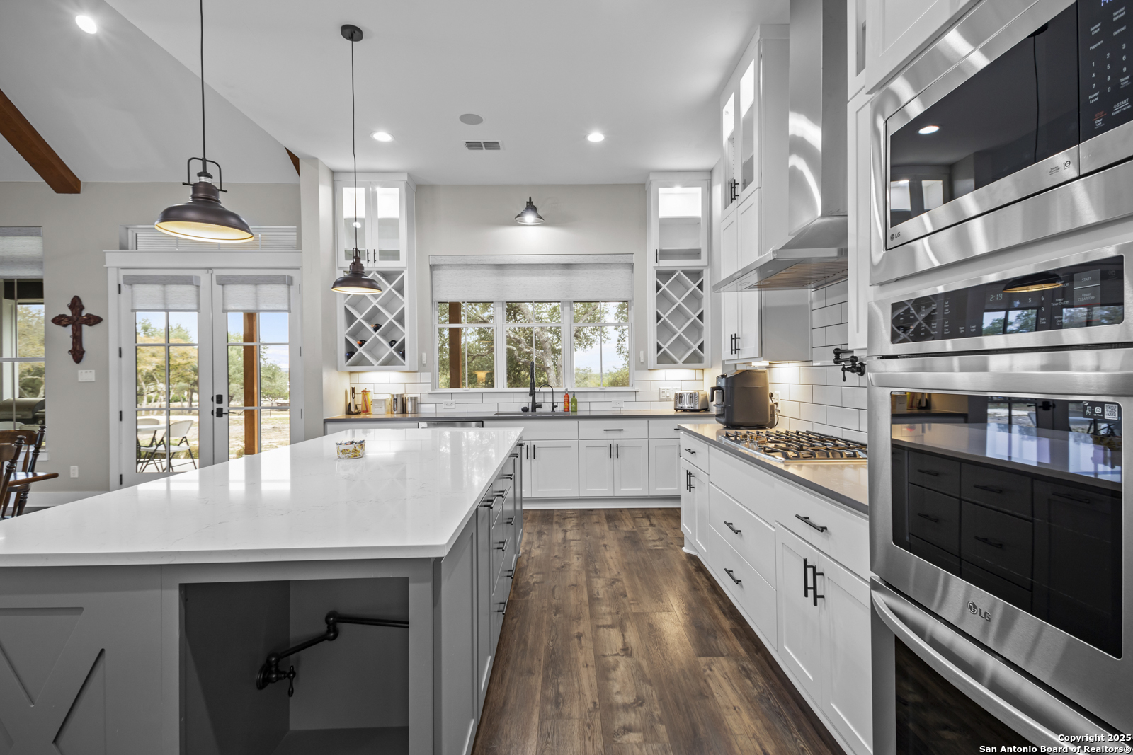 209 River Ridge Boerne, TX 78006 - Photo 12 of 60 a large kitchen with kitchen island a large counter space a sink appliances and living room view