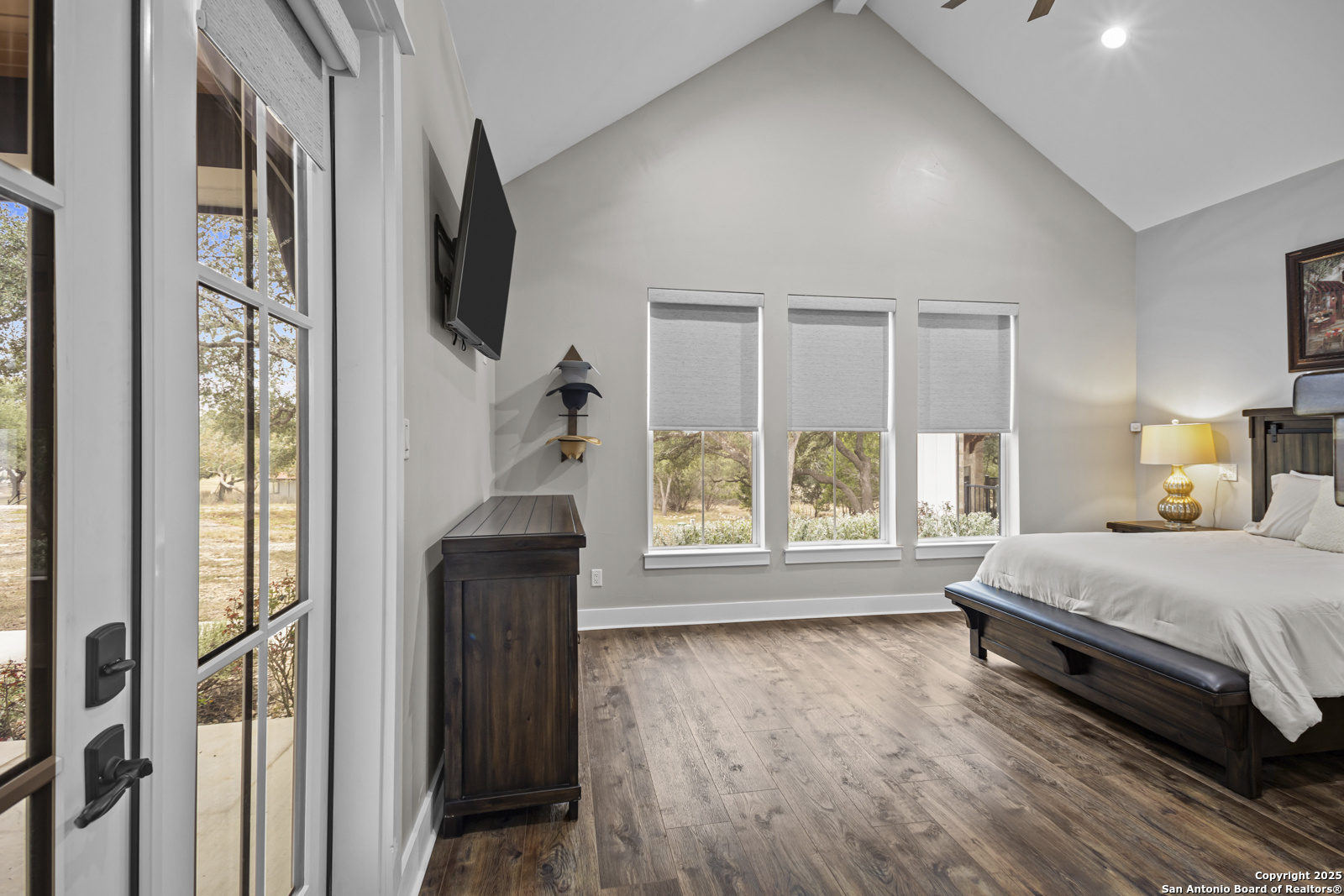 209 River Ridge Boerne, TX 78006 - Photo 17 of 60 a bedroom with a bed and a flat tv screen next to a window