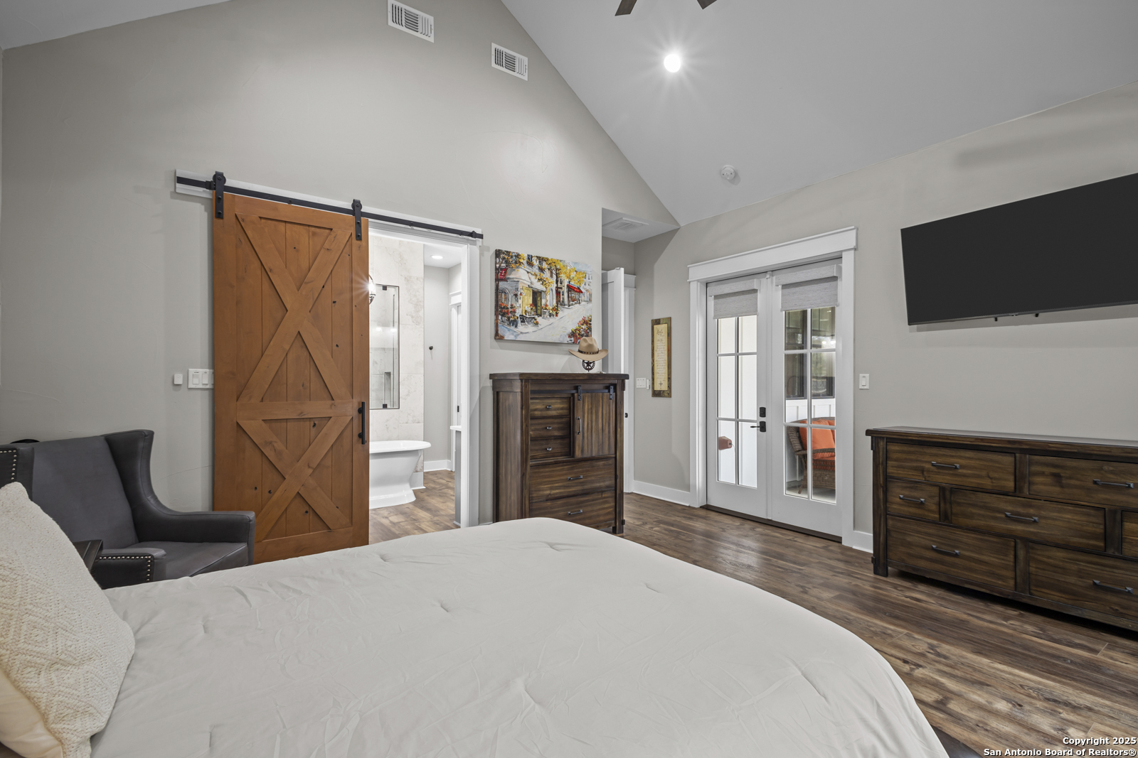 209 River Ridge Boerne, TX 78006 - Photo 18 of 60 a bedroom with a bed and a flat screen tv