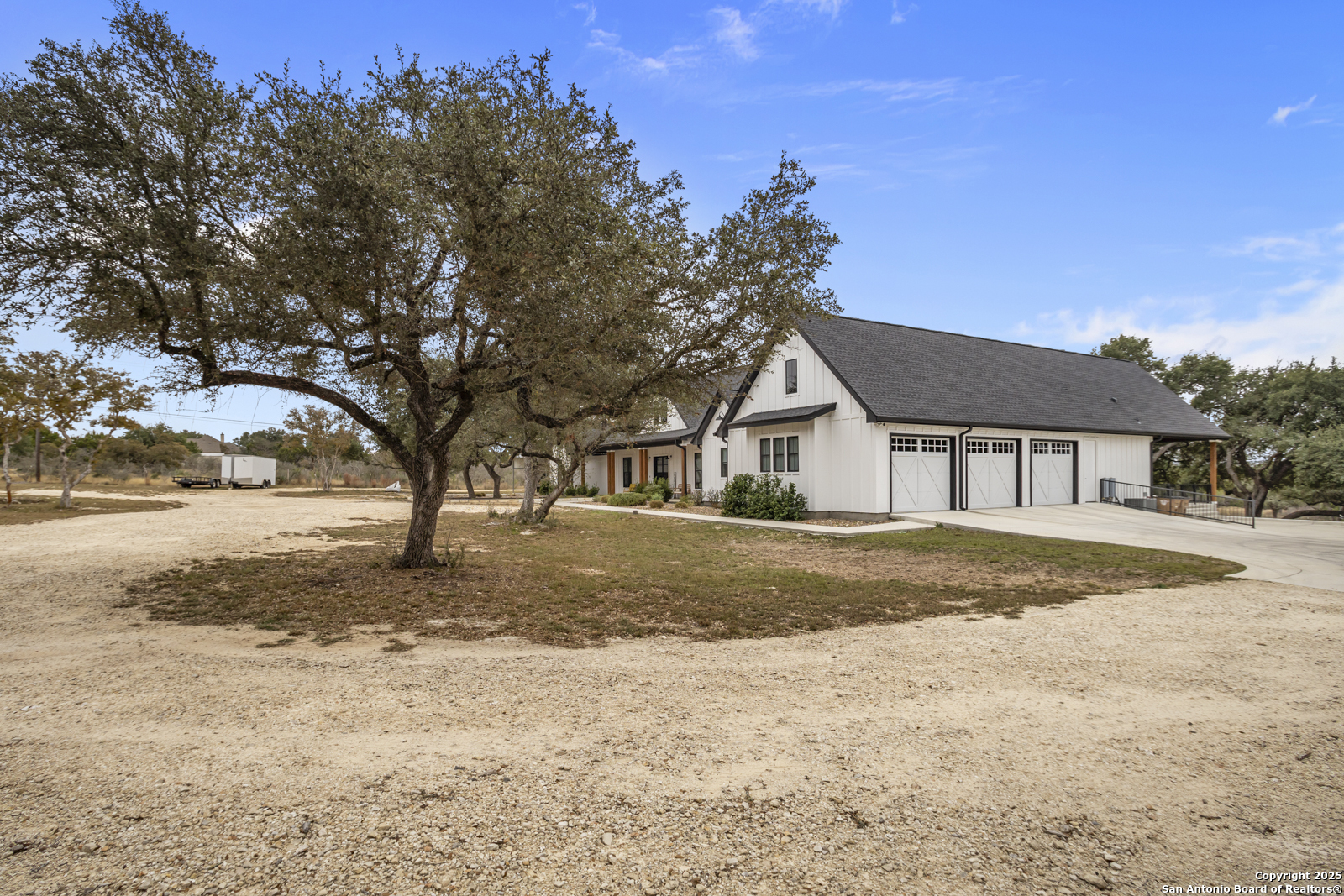 209 River Ridge Boerne, TX 78006 - Photo 2 of 60 a front view of a house with a yard covered with snow