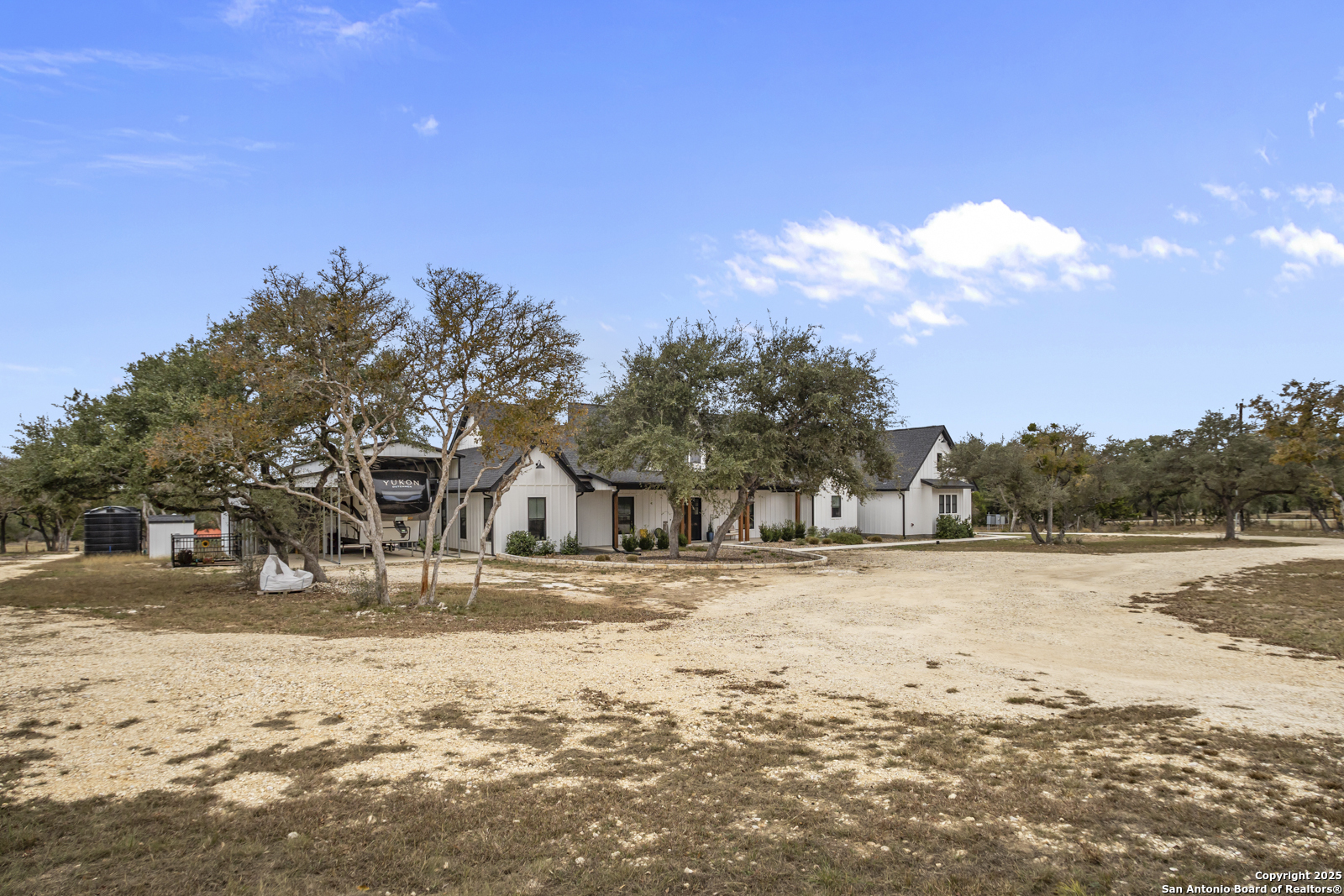 209 River Ridge Boerne, TX 78006 - Photo 3 of 60 a view of large house with a yard covered in snow