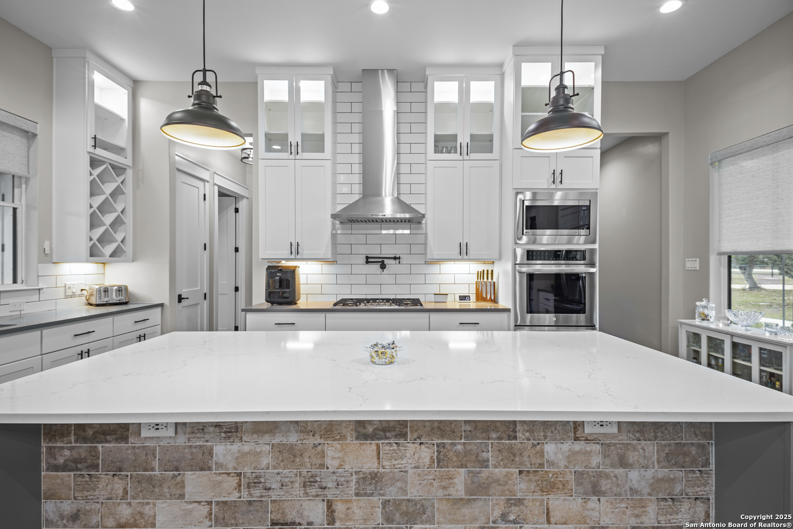 209 River Ridge Boerne, TX 78006 - Photo 8 of 60 a large kitchen with stainless steel appliances a stove a refrigerator a oven a white table and chairs