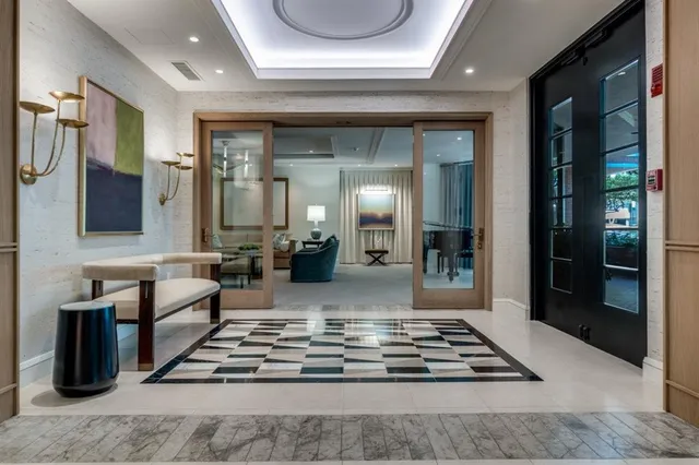 a living room with furniture and a chandelier
