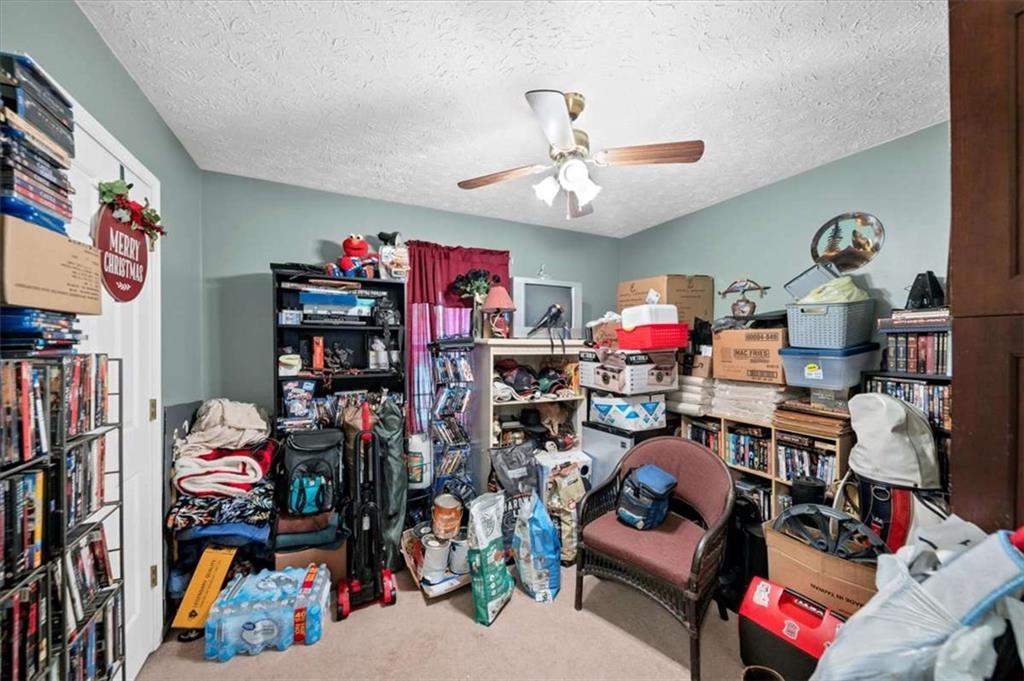 221 Pleasant Way Temple, GA 30179 - Photo 21 of 35 a living room with lots of furniture and clutter