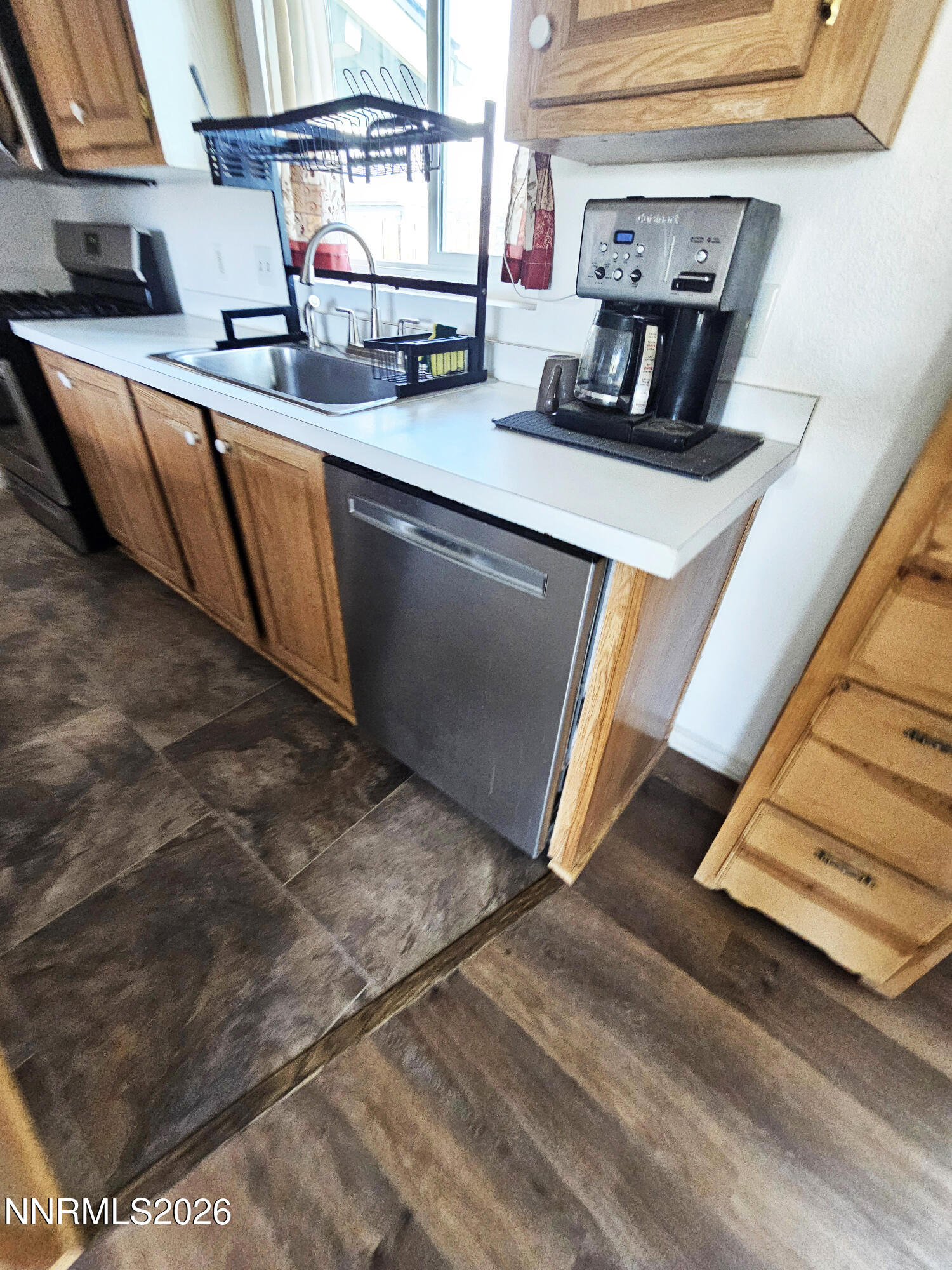 1125 Rancho Road Fernley, NV 89408 - Photo 12 of 47 a kitchen with stainless steel appliances granite countertop a sink and a stove