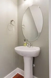 a bathroom with a sink a mirror and vanity