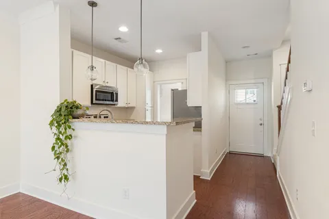 a view of a hallway to dining room with wooden floor