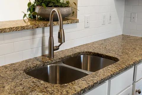 a view of a kitchen counter top a sink and dishwasher