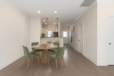 a view of a dining room with furniture and wooden floor