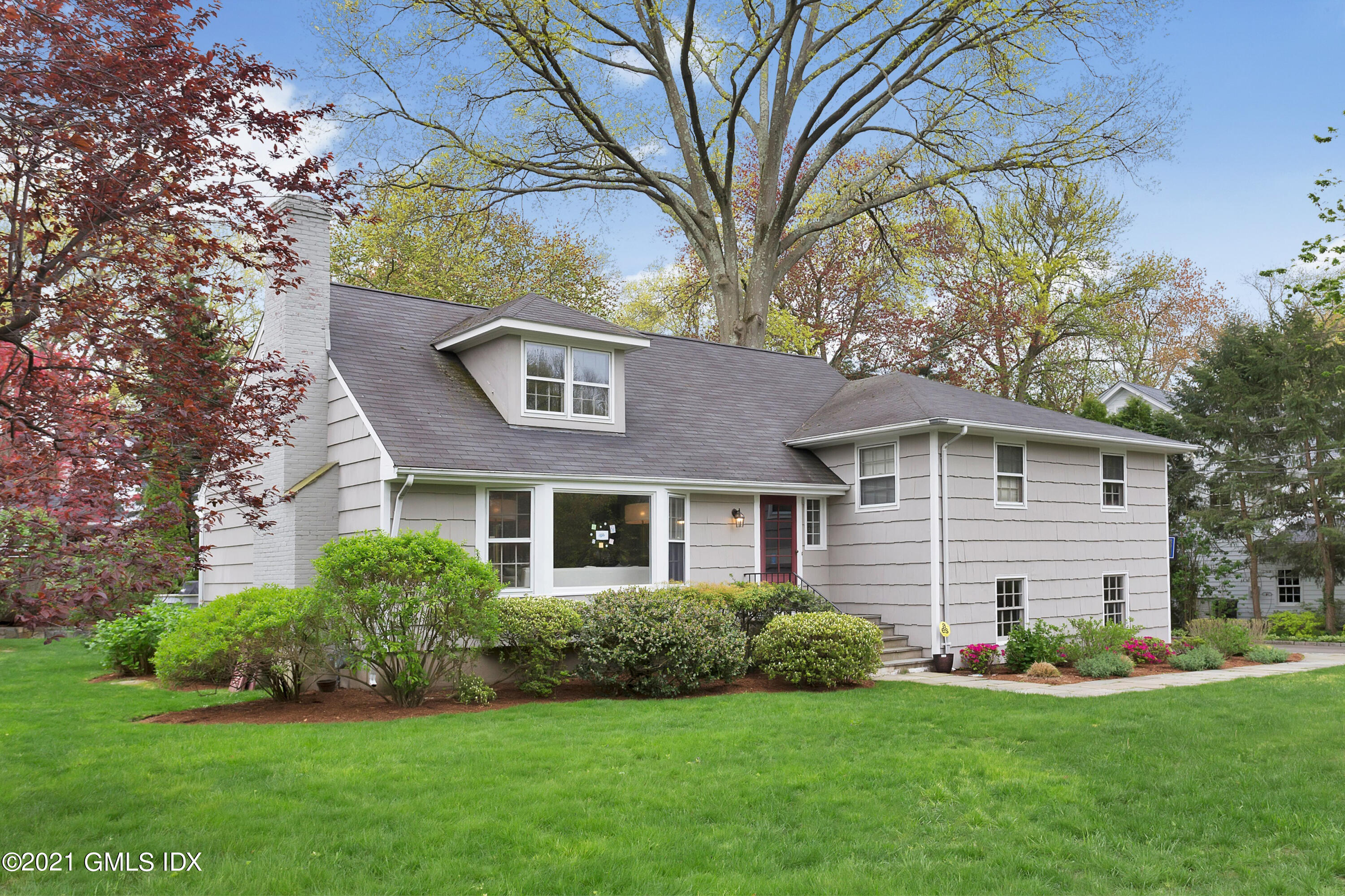 a front view of a house with a garden