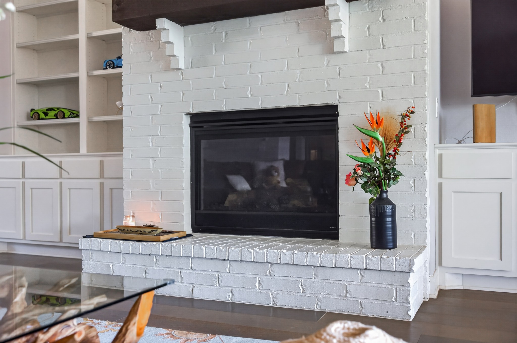 4105 Haight Street Round Rock, TX 78681 - Photo 12 of 40 White-painted brick fireplace with a dark wood mantel and a built-in firebox