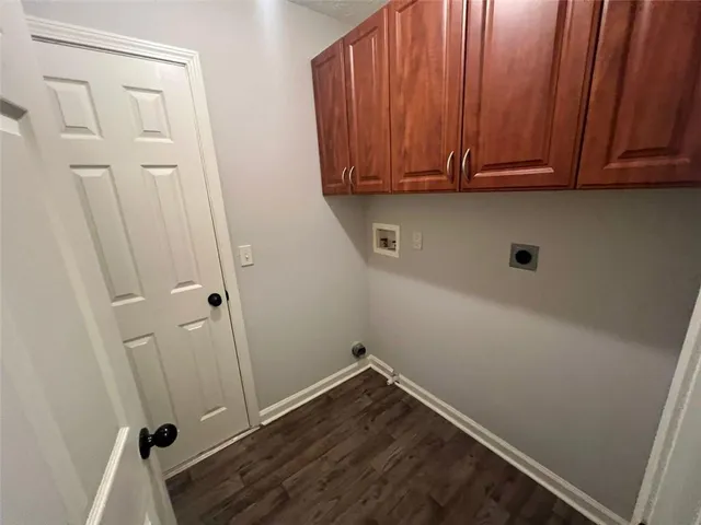 a view of storage and utility room with wooden floor