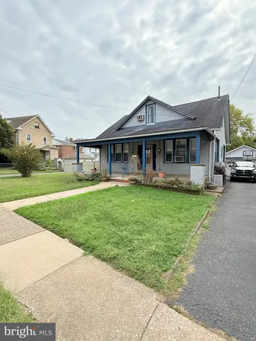 a front view of a house with a yard table and chairs