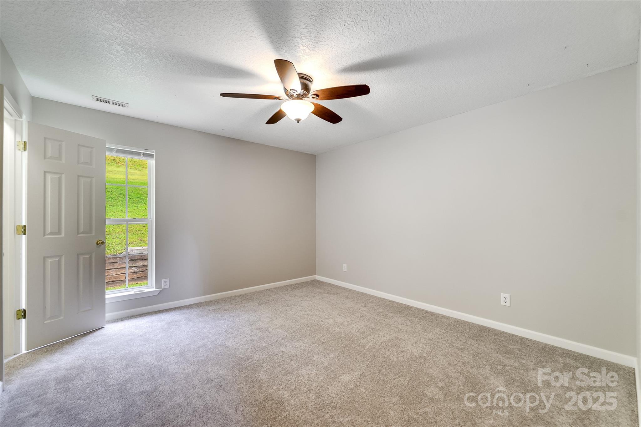 1061 Calvary Church Road Sylva, NC 28779 - Photo 21 of 46 an empty room with closet and windows