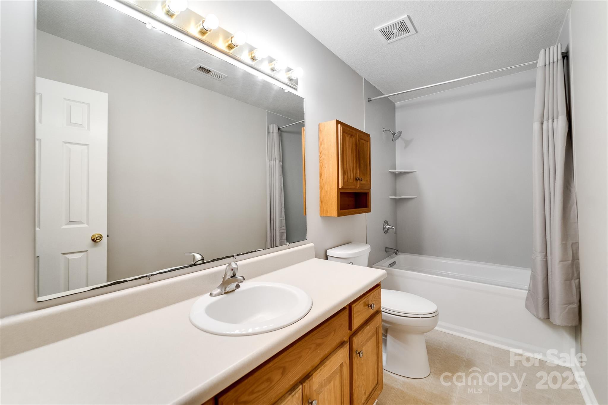 1061 Calvary Church Road Sylva, NC 28779 - Photo 23 of 46 a bathroom with a granite countertop sink toilet and shower