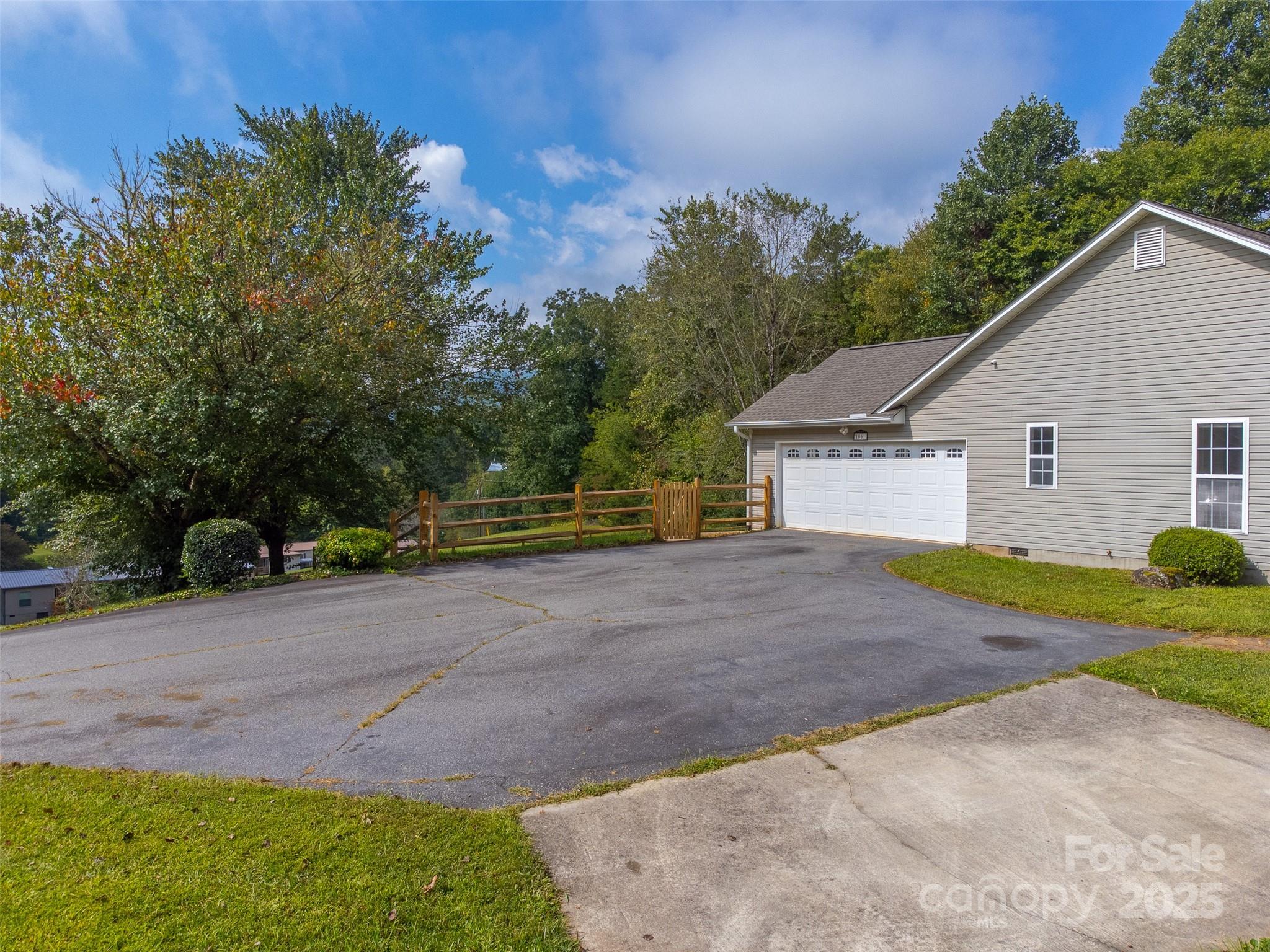 1061 Calvary Church Road Sylva, NC 28779 - Photo 27 of 46 a view of a yard with plants and a tree