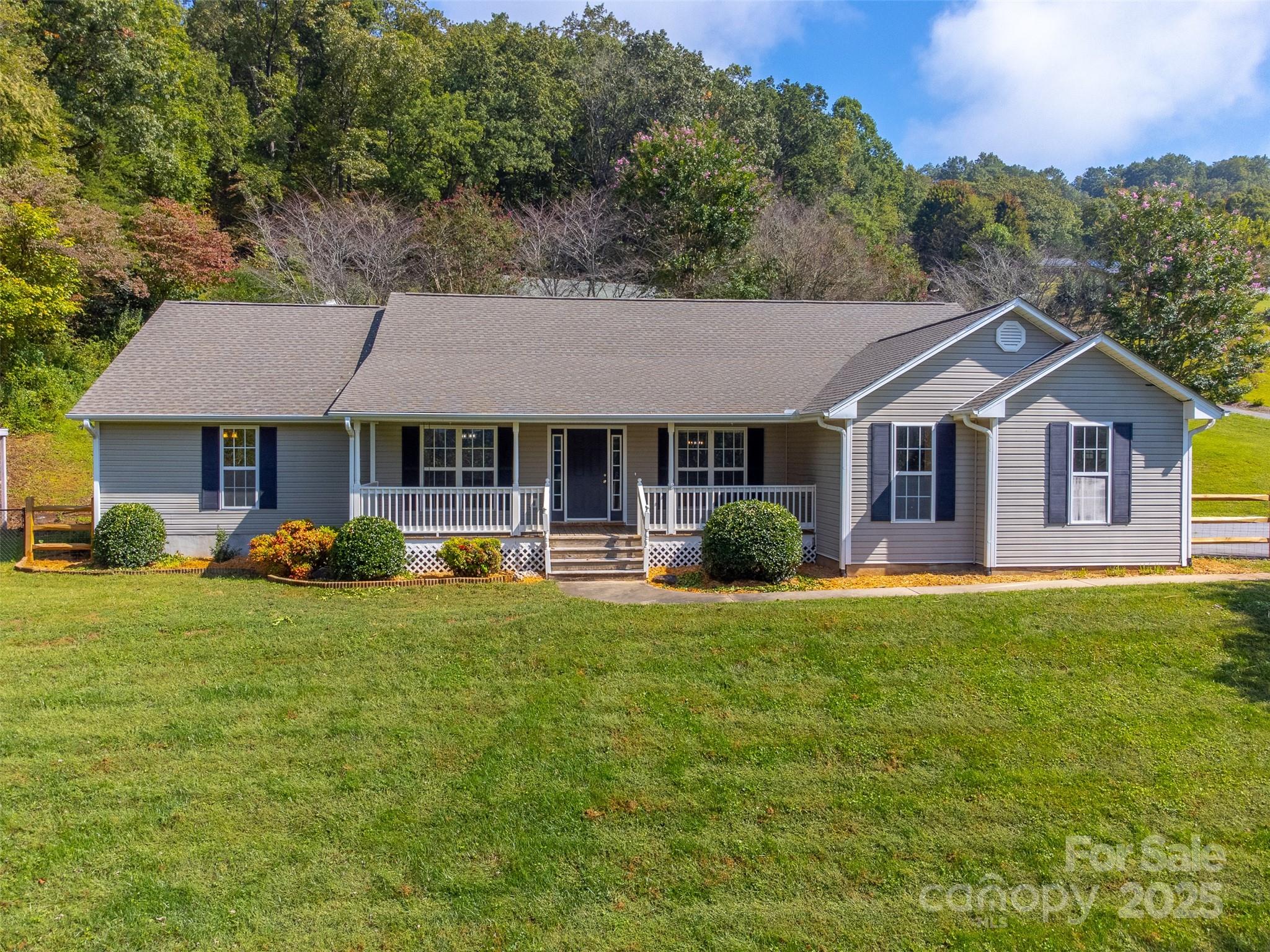 1061 Calvary Church Road Sylva, NC 28779 - Photo 3 of 46 a front view of a house with yard patio and green space