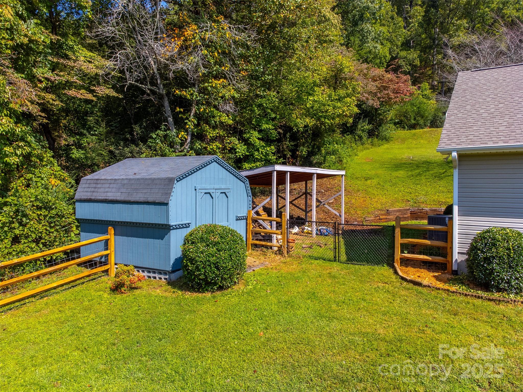 1061 Calvary Church Road Sylva, NC 28779 - Photo 35 of 46 a view of a backyard with table and chairs with wooden fence and plants