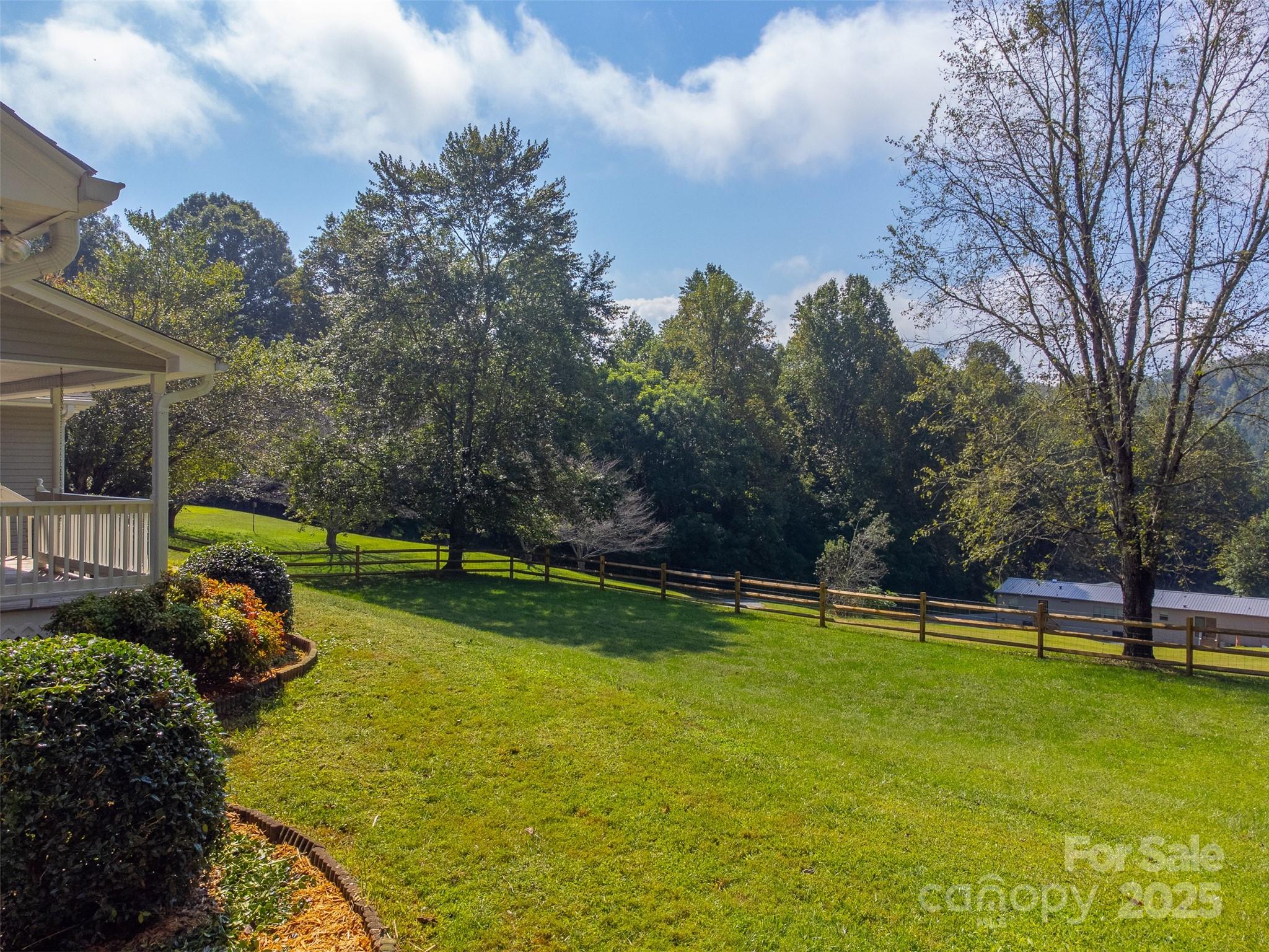1061 Calvary Church Road Sylva, NC 28779 - Photo 36 of 46 a view of a golf course with a wooden fence
