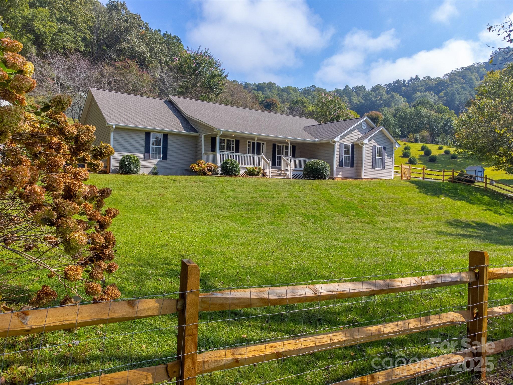 1061 Calvary Church Road Sylva, NC 28779 - Photo 4 of 46 a front view of a house with a garden