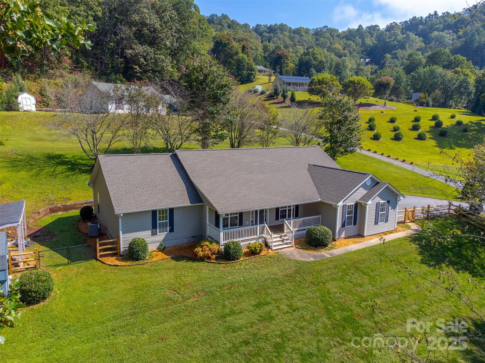 1061 Calvary Church Road Sylva, NC 28779 - Photo 43 of 46 an aerial view of a house with swimming pool and green space