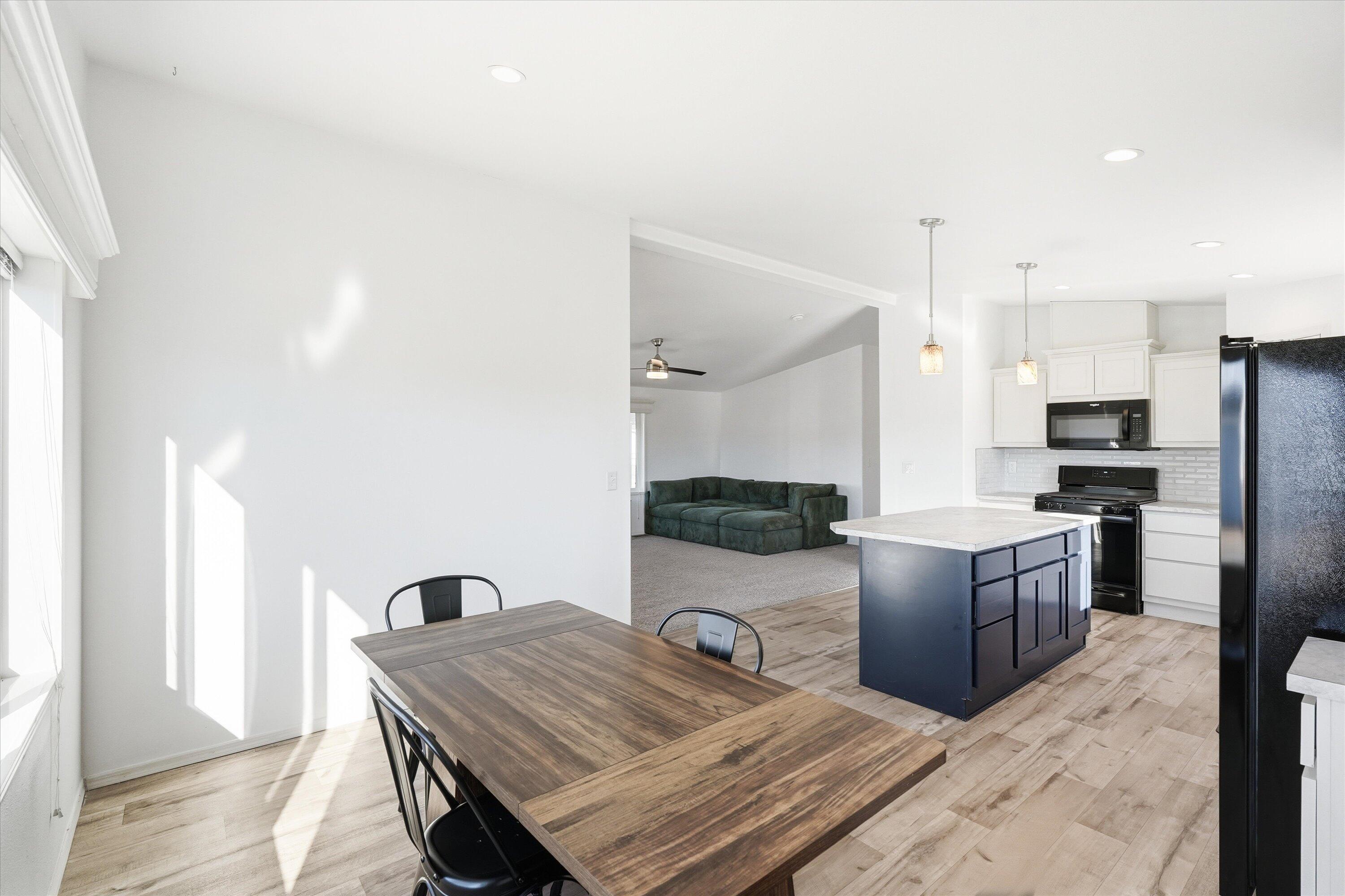 300 Luman Road, Unit 197 Phoenix, OR 97535 - Photo 12 of 26 a kitchen with sink refrigerator dining table and chairs