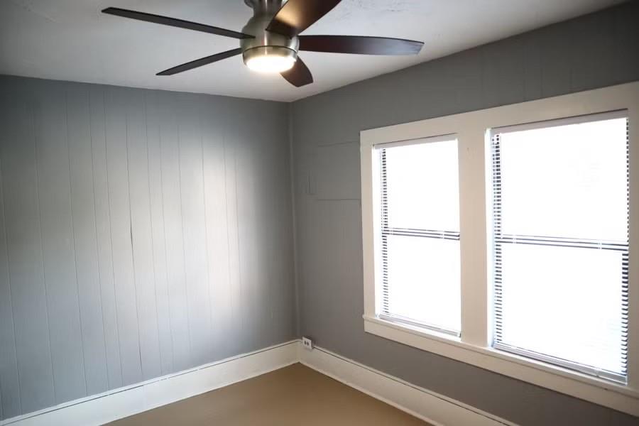 Empty room with baseboards and ceiling fan