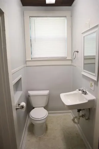 a white toilet sitting next to a bathroom sink
