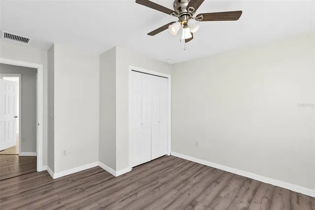 a view of an empty room with wooden floor