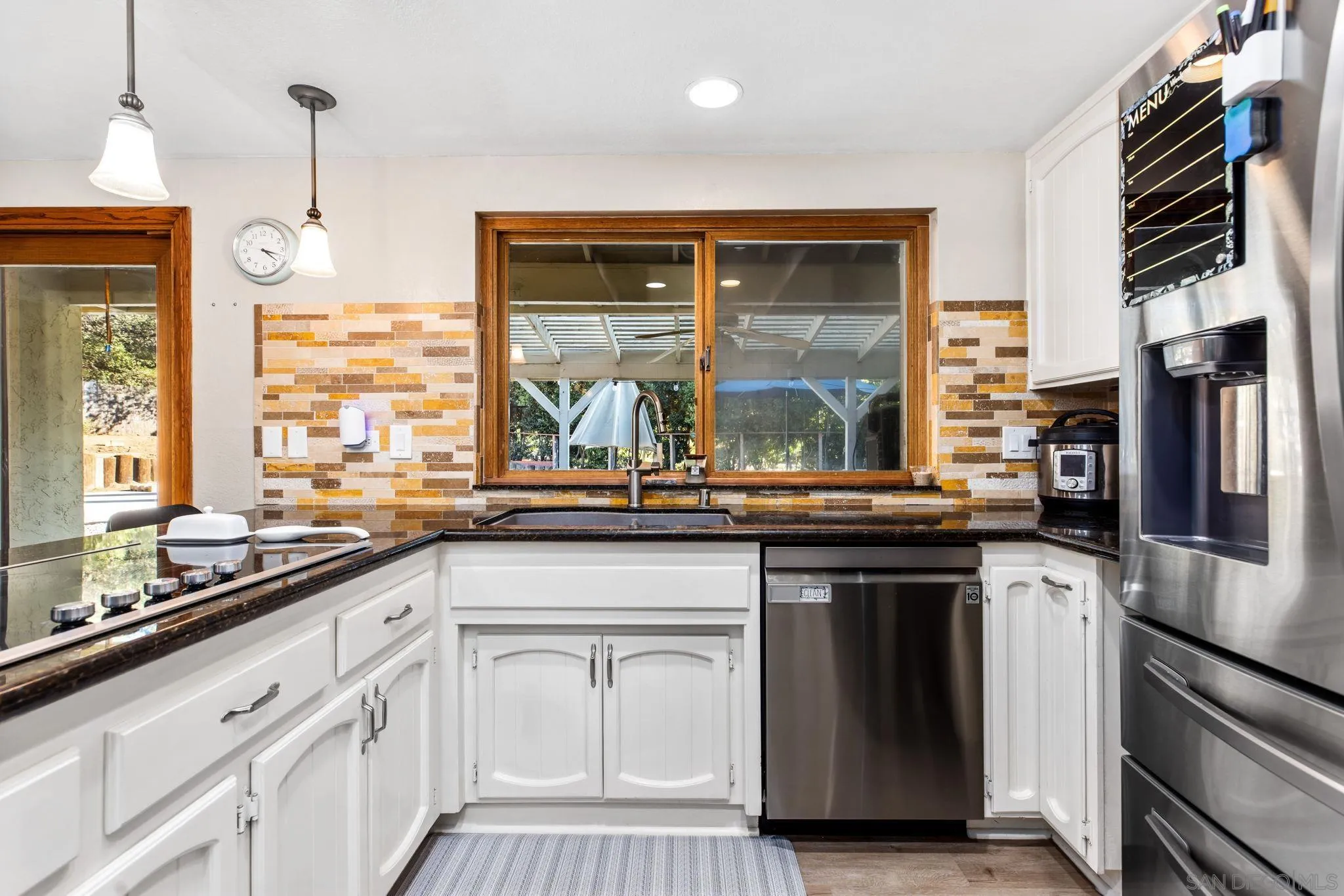 16614 Wikiup Road Ramona, CA 92065 - Photo 14 of 37 a kitchen with stainless steel appliances granite countertop a stove and a sink