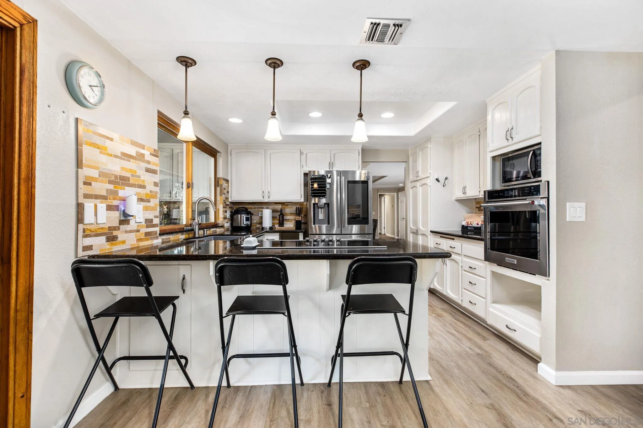 16614 Wikiup Road Ramona, CA 92065 - Photo 9 of 37 a kitchen with stainless steel appliances granite countertop a kitchen island a stove a table and chairs in it