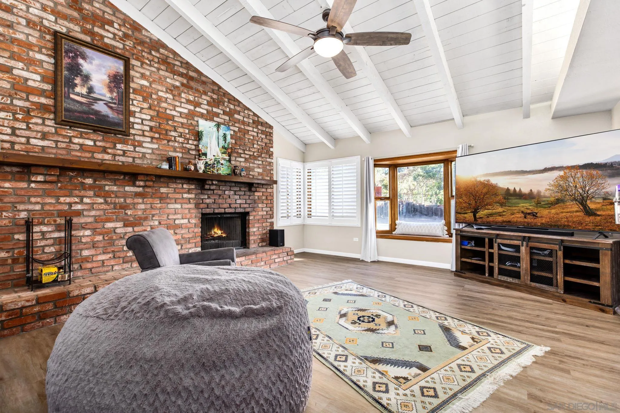 16614 Wikiup Road Ramona, CA 92065 - Photo 10 of 37 a living room with a large bed and a fireplace