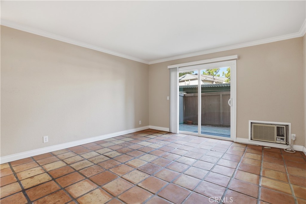 20702 El Toro Road, Unit 231 Lake Forest, CA 92630 - Photo 7 of 36 a view of an empty room with window and chandelier fan