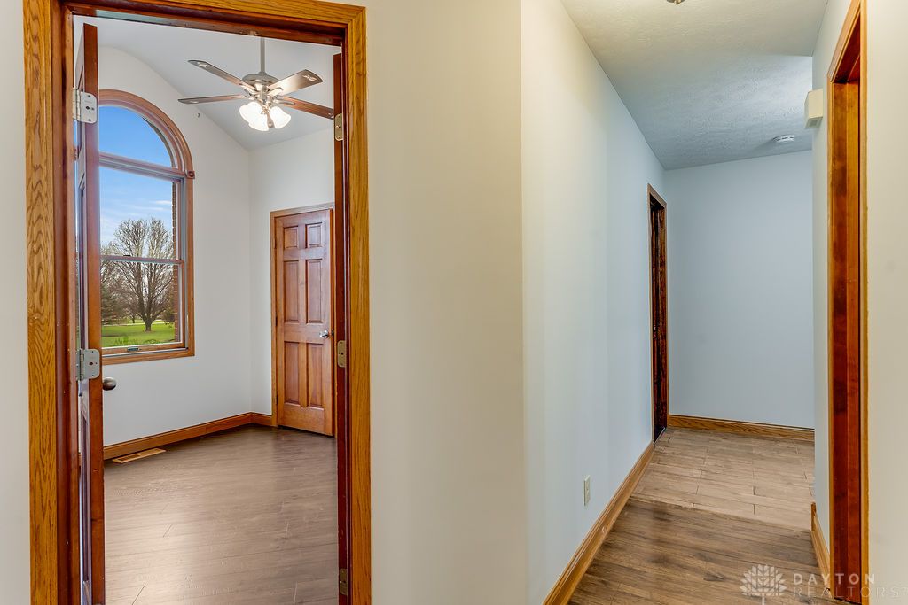 7400 Cook-Jones Road Waynesville, OH 45068 - Photo 19 of 72 This bright room features a large arched window overlooking expansive greenery, complemented by rich hardwood flooring.