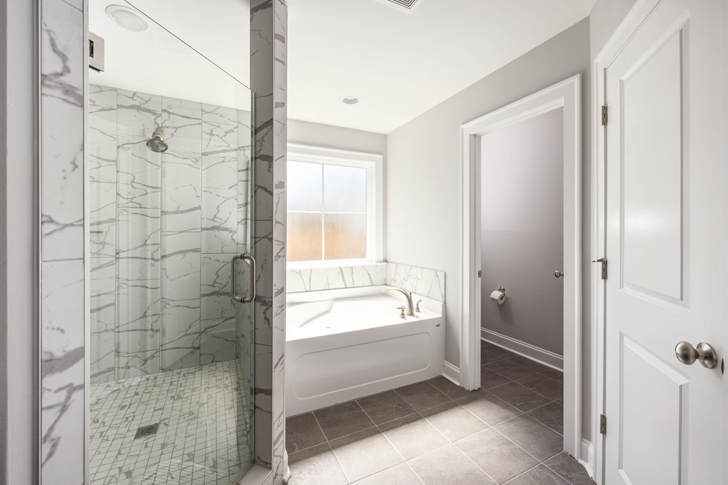 50 Ivy Loop Phenix City, AL 36867 - Photo 13 of 23 a bathroom with a bathtub and a shower